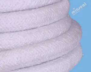 Close-up of coiled white rope against a blue background.