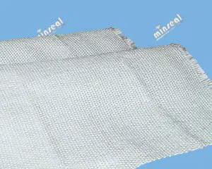 A piece of white industrial fabric with frayed edges is shown against a blue background.