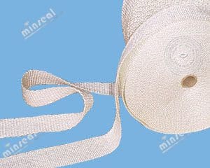 A roll of white woven fabric tape is unspooled on a blue background.