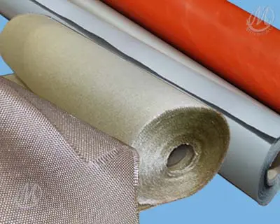 Several rolls of industrial fabric and material in various colors and textures are displayed on a blue background.