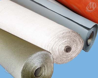 Close-up of four differently colored fabric rolls on a blue background, including beige, gray, and orange hues.