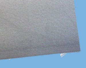 Gray textile material on light blue background.