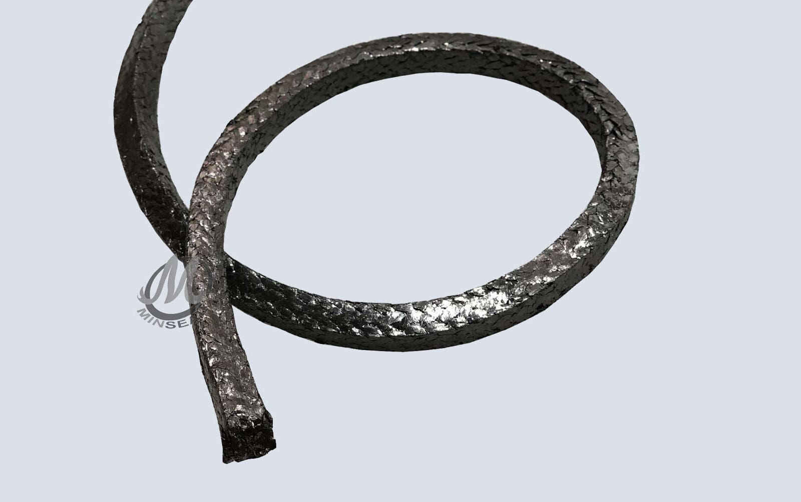 GB1000-2a-e1695161767495 Braided metallic rope on plain background.