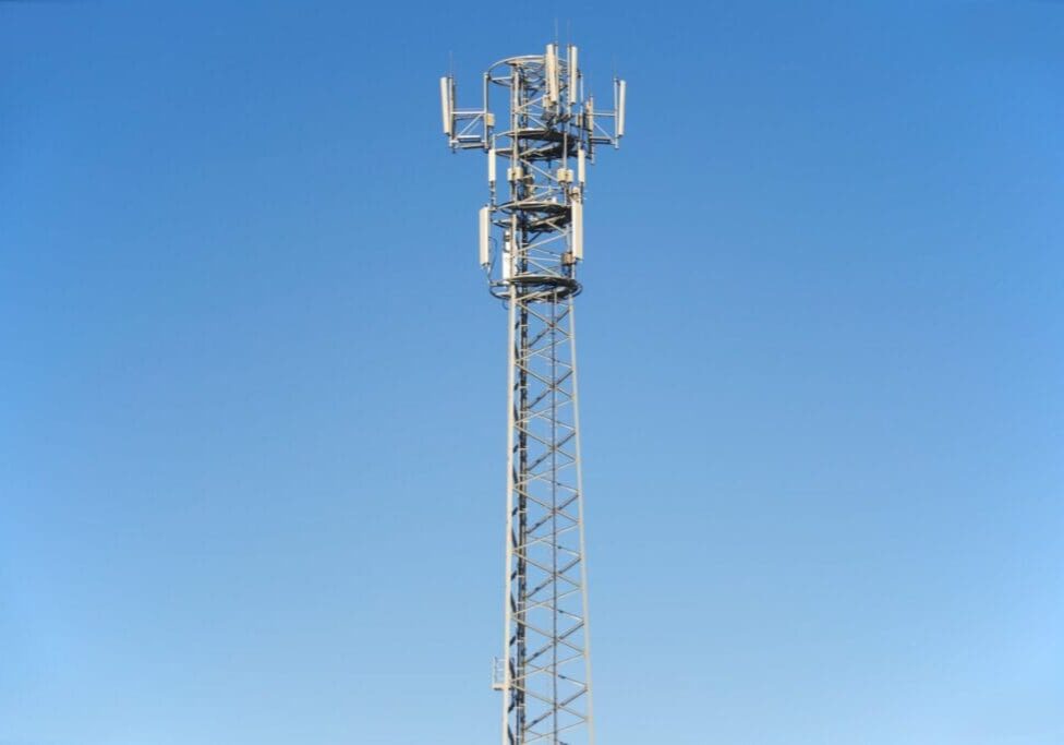 A tall communication tower against a clear blue sky.